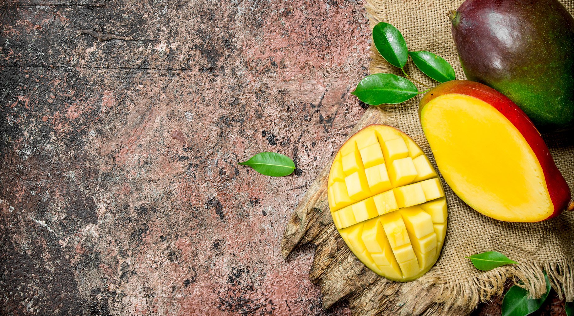 sliced mango on sack and stone